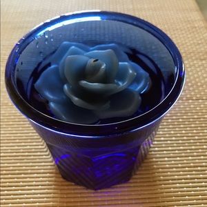 Blue glass with floating cand